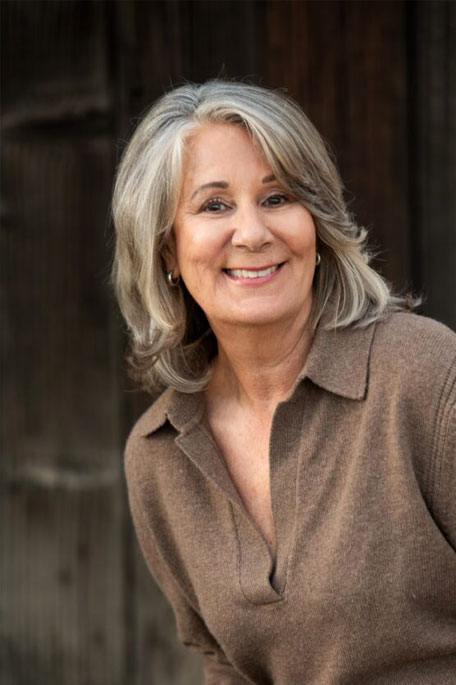 Color image of Karen Cakebread smiling in a brown shirt.