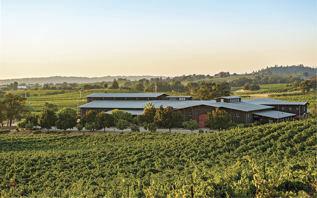 Color image panned out of Montevina Winery with vineyards in the foreground in the Sierra Foothills in CA.