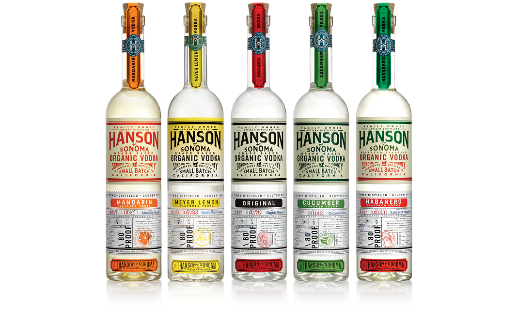 Color image of 5 bottles of Hanson of Sonoma organic vodka in order of Mandarin Orange, Meyer Lemon, Original, Cucumber, and Habanero Pepper.